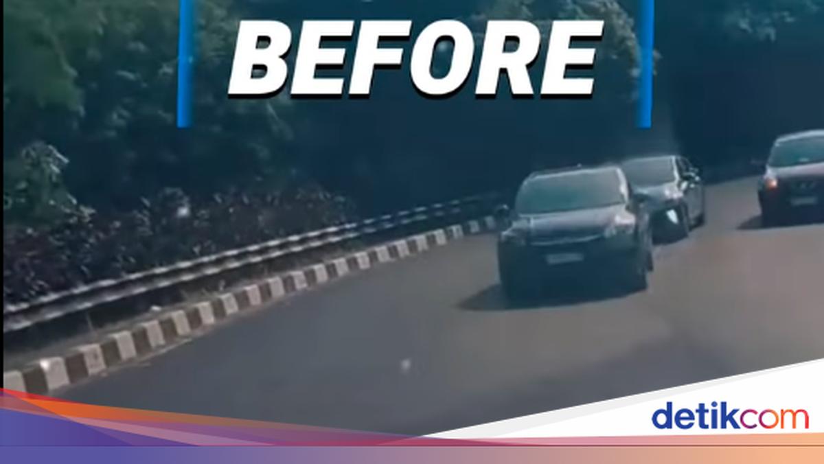 Newly repainted white lane markings on the asphalt of Akses UI Road in Depok