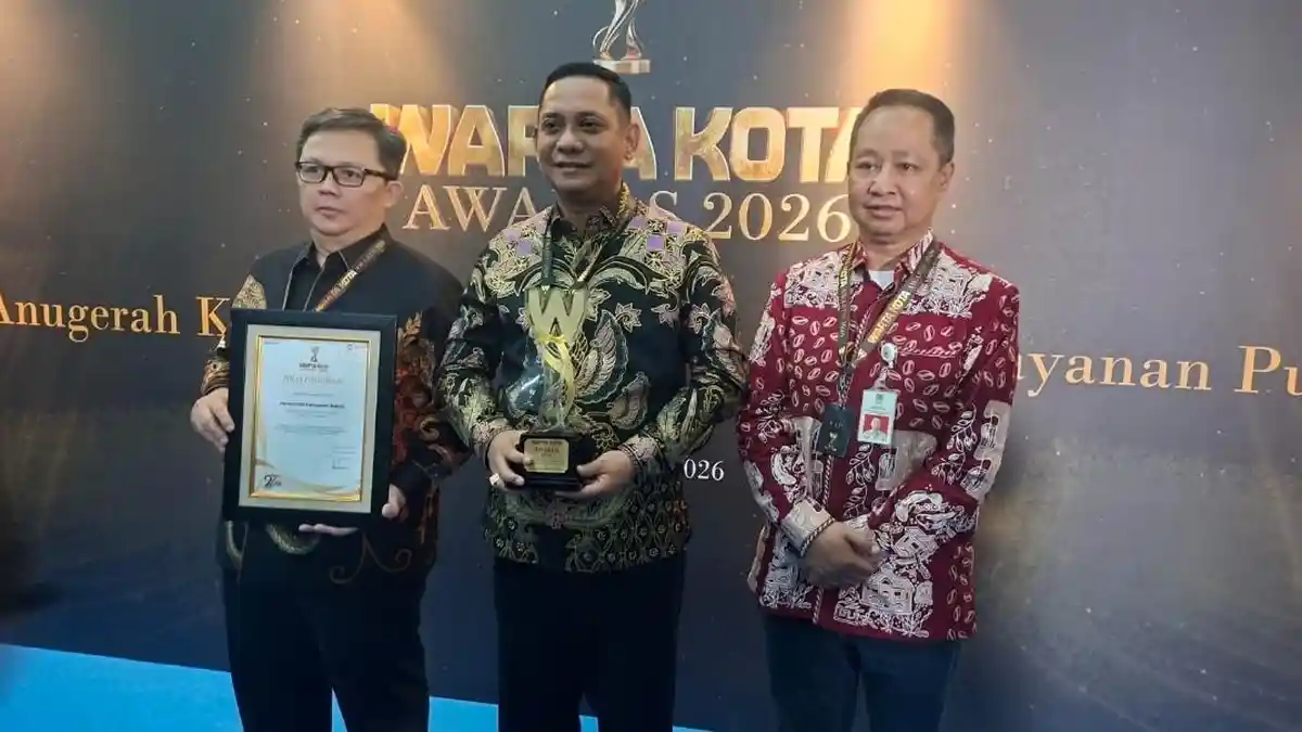 Acting Bekasi Regent Asep Surya Atmaja receiving the healthcare excellence award at Menara Kompas