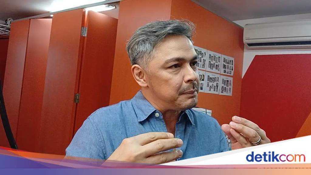 Thomas Djorghi looking reflective during a television studio interview in Jakarta.