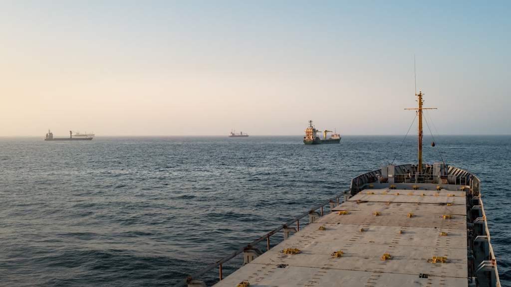 Commercial cargo ships and oil tankers navigating the Strait of Hormuz waterway
