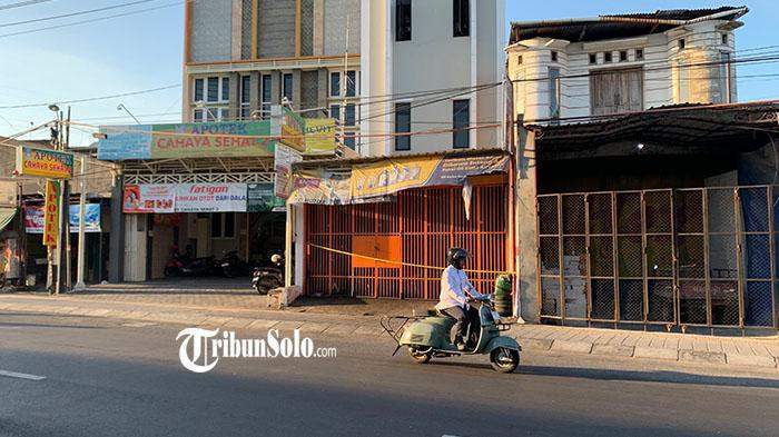 Police investigate the scene of a fatal freight elevator crash at a workshop in Solo.