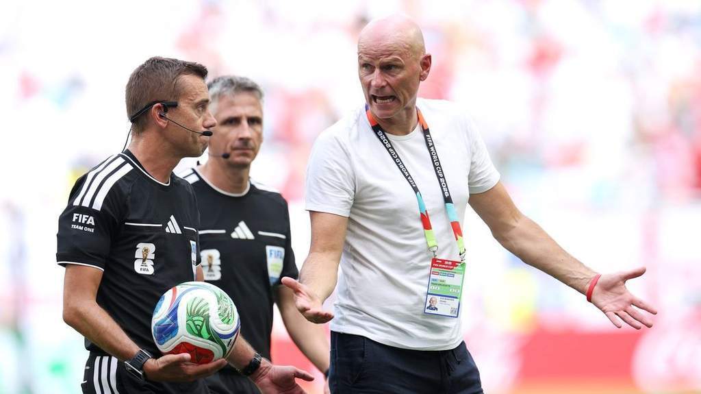 Norway coach Stale Solbakken talks to referee Clement Turpin during World Cup match
